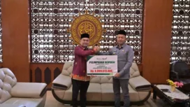 Bupati Aceh Jaya, Safwandi menerima deviden Tahun Buku 2024 dari Bank Aceh Syariah Cabang Calang senilai Rp 6.899.613.406 di Ruang Kerja Bupati Aceh Jaya, Jumat (21/3/2025) (Foto/Ist)